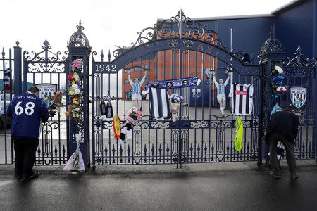 Fans leave tributes to Cyrille Regis at the Jeff Castle gates of West Bromwich Albion football club's The Hawthorns stadium in West Bromwich, Britain January 15, 2018. REUTERS/Darren Staples