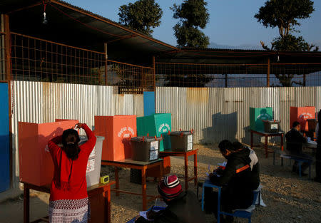 A woman (L) casts her vote in a ballot box during the parliamentary and provincial elections at Chautara in Sindhupalchok District November 26, 2017. REUTERS/Navesh Chitrakar