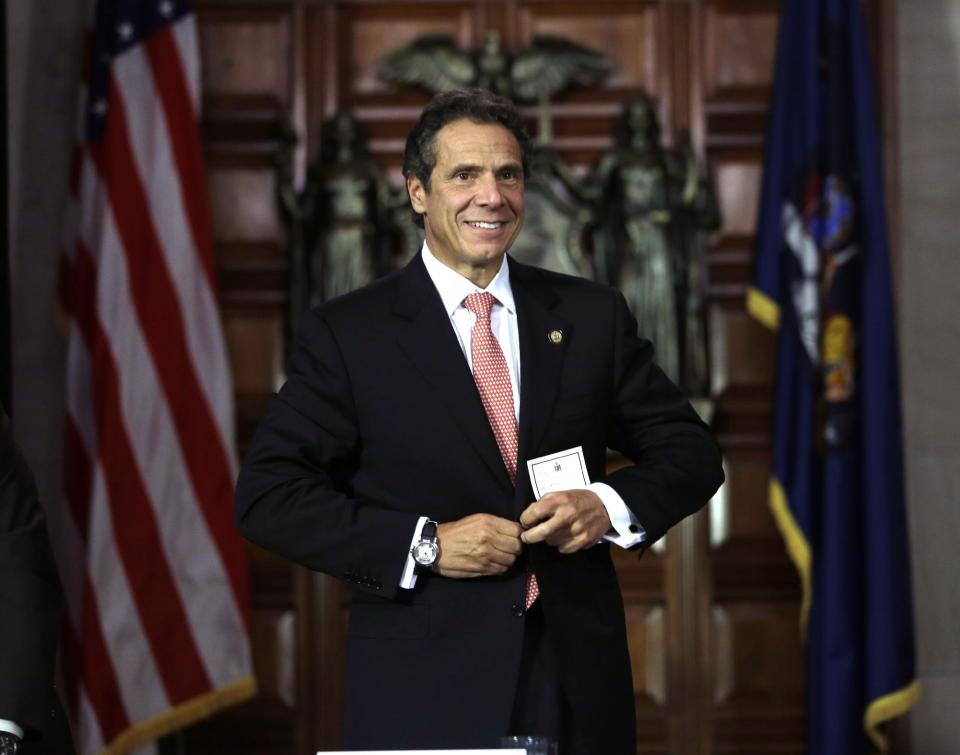 New York Gov. Andrew Cuomo buttons his jacket after a cabinet meeting in the Red Room at the Capitol on Thursday, Sept. 27, 2012, in Albany, N.Y. Cuomo is calling a summit to boost the beer and wine industries in New York just months after a similar effort began to try to make New York the nations largest producer of Greek-style yogurt. (AP Photo/Mike Groll)