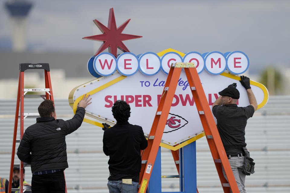 Workers prepare a welcome to Las Vegas sign in preparation of team arrivals ahead of the NFL Super Bowl 58 football game between the San Francisco 49ers and the Kansas City Chiefs Sunday, Feb. 4, 2024, in Las Vegas. (AP Photo/David J. Phillip)