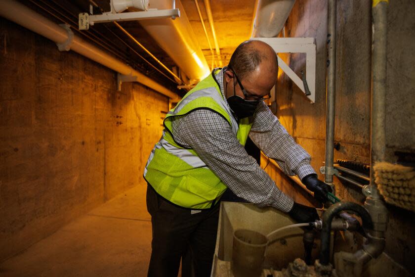 SAN JOSE, CA - APRIL 1: San José-Santa Clara Regional Wastewater Facility Deputy Director Amit Mutsuddy demonstrates how the agency staff collects primary sludge samples to send to a lab to test for various viruses including influenza, in San Jose, Calif., on April 1, 2022. (Photo by Dai Sugano/MediaNews Group/The Mercury News via Getty Images)