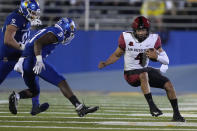 San Diego State quarterback Jordon Brookshire (4) scrambles away from San Jose State safety Jay Lenard (27) and defensive lineman Cade Hall, left, during the first half of an NCAA college football game Friday, Oct. 15, 2021, in San Jose, Calif. (AP Photo/Tony Avelar)
