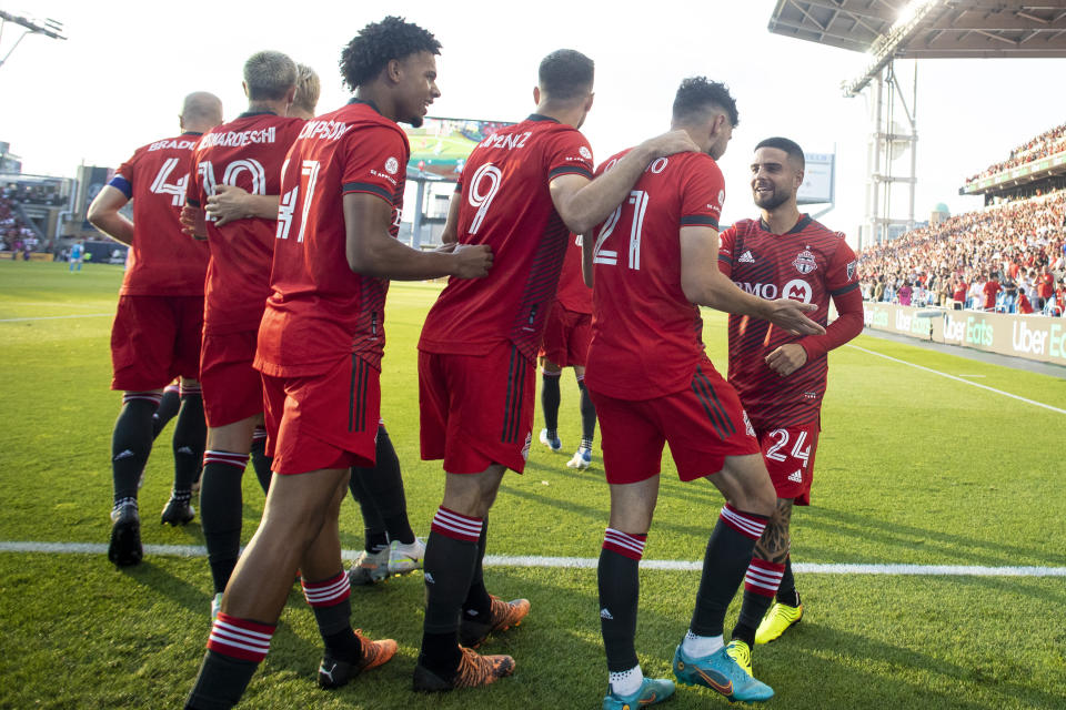 Toronto FC midfielder Jonathan Osorio (21) celebrates with teammates after scoring the first goal of an MLS soccer match against Charlotte FC during the first half in Toronto, Saturday July 23, 2022. (Chris Young/The Canadian Press via AP)