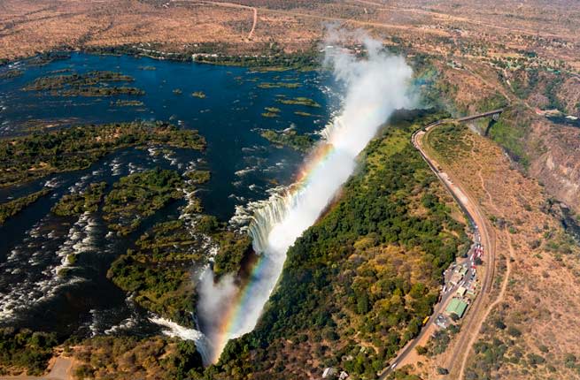 <p><b>Where: </b>Zambia/Zimbabwe</p> <p>Gliding in a tiny Microlight open to the elements can make anyone feel small, but when it’s the Flight of Angels circling the mighty wonder of the world, , the experience is completely liberating. As you straddling borders, views of the powerful waterfall and gushing Zambezi River are sure to spur an incredible rush of adrenaline.</p> <p><b>Insider Tip</b>: You can also opt for a helicopter tour if being enclosed makes you feel safer, by arranging flights with experienced pilots. Get a DVD of your trip afterward as a souvenir if you can arrange it.</p>