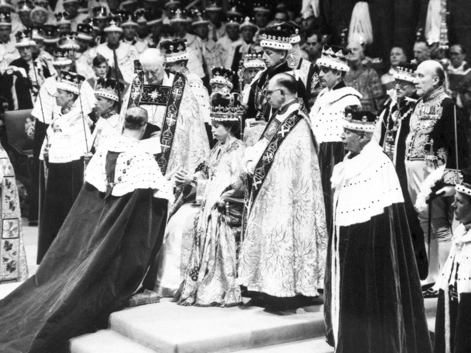 Prince Philip bows to Queen Elizabeth II during her coronation.