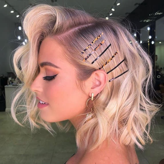 <p>Give your long bob haircut a touch of vintage flair with a deep side part and big brushed-out curls. Bobby pins and barrettes will be your best accessory to add a little bit of elegance to this already-classic cut. </p>