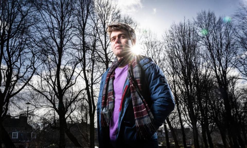 Daniel Walker shot against a backdrop of winter trees and blue sky with the sun  on his shoulder