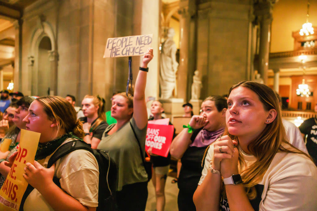 Abortion rights activists react after the Indiana Senate