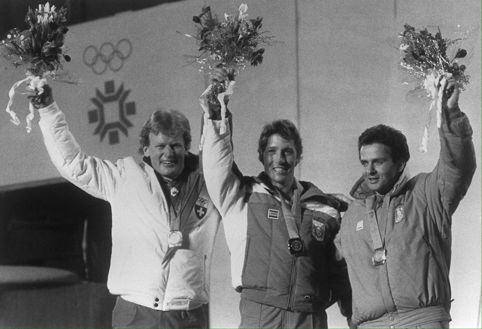 Gold medal winner Bill Johnson (C) of the US is flanked by Peter M¸ller (L) of Switzerland and Anton Steiner (R) of Austria on the medals' podium for the men's downhill in Sarajevo 16 February 1984 at the Winter Olympic Games.