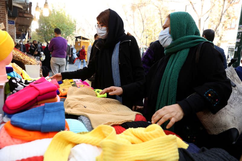 FILE PHOTO: Women shop at a street in Tehran