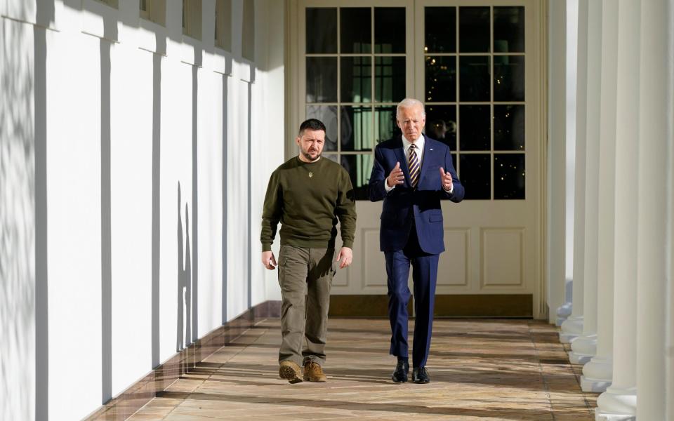 Mr Zelensky and Mr Biden walk along the White House Colonnade - AP