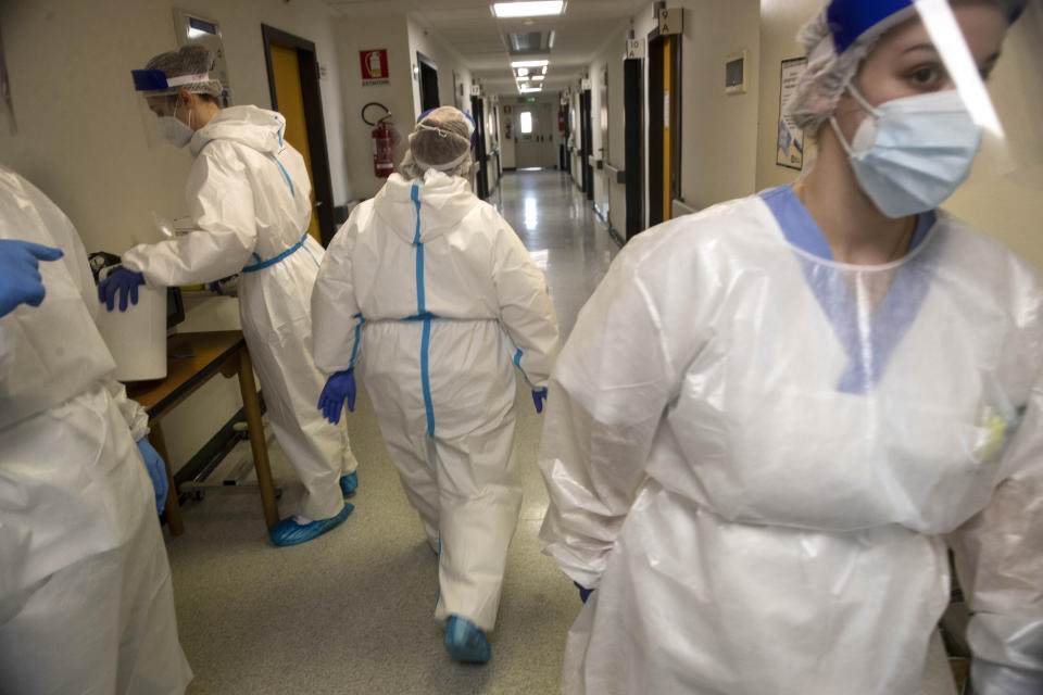 Nurses work in the COVID-19 ward at the Mellino Mellini hospital in Chiari, northern Italy, Monday, March 8, 2021. The 160-bed hospital in the Po River Valley town of Chiari has no more beds for patients stricken with the highly contagious variant of COVID-19 first identified in Britain, and which now has put hospitals in Italy’s northern Brescia province on high alert. (AP Photo/Luca Bruno)