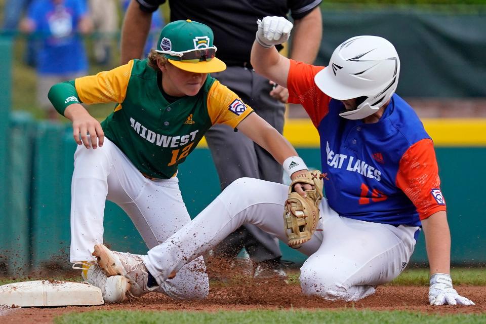 Davenport, Iowa's Colin Townsend (12) tags out Hagerstown, Ind.'s Graham Vinson (13) at third base during a Little League World Series game in South Williamsport, Pa., on Thursday.