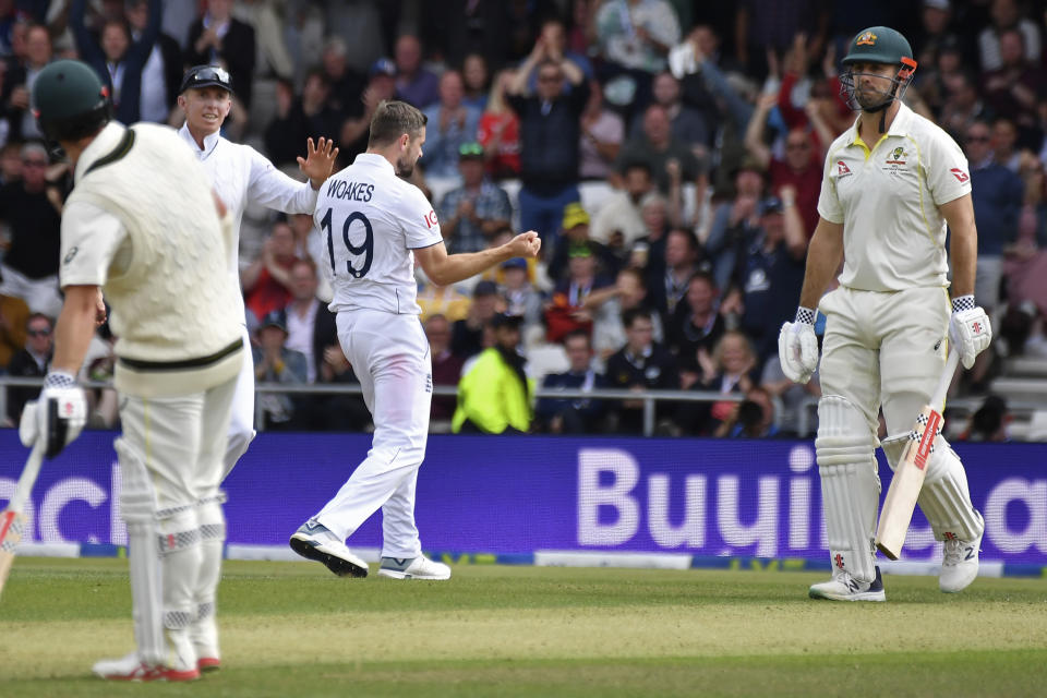 England's Chris Woakes, center, celebrates the dismissal of Australia's Mitchell Marsh, right, during the first day of the third Ashes Test match between England and Australia at Headingley, Leeds, England, Thursday, July 6, 2023. (AP Photo/Rui Vieira)