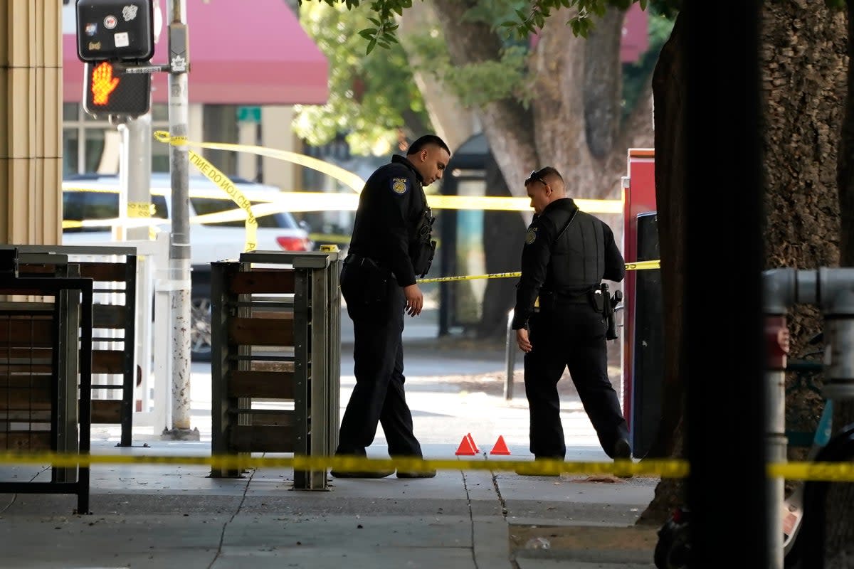 Police search the scene for clues after the nightclub shooting  (AP)