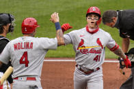 St. Louis Cardinals' Tyler O'Neill (41) celebrates with Yadier Molina (4) as he heads to the dugout after hitting a two-run home run off Pittsburgh Pirates starting pitcher Trevor Williams during the second inning of the first baseball game of a doubleheader in Pittsburgh, Friday, Sept. 18, 2020. (AP Photo/Gene J. Puskar)