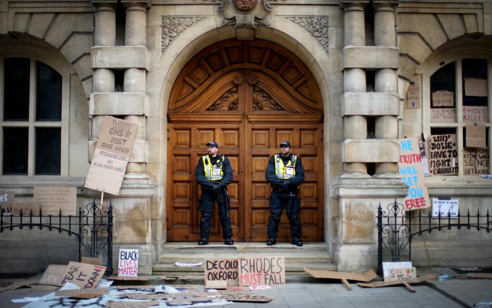 Police stand outside Oriel College, Oxford  - Getty