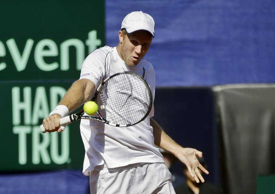 Britain's Dominic Inglot returns a shot from the United States team during a doubles match at the Davis Cup tennis matches, Saturday, Feb. 1, 2014, in San Diego. (AP Photo/Lenny Ignelzi)