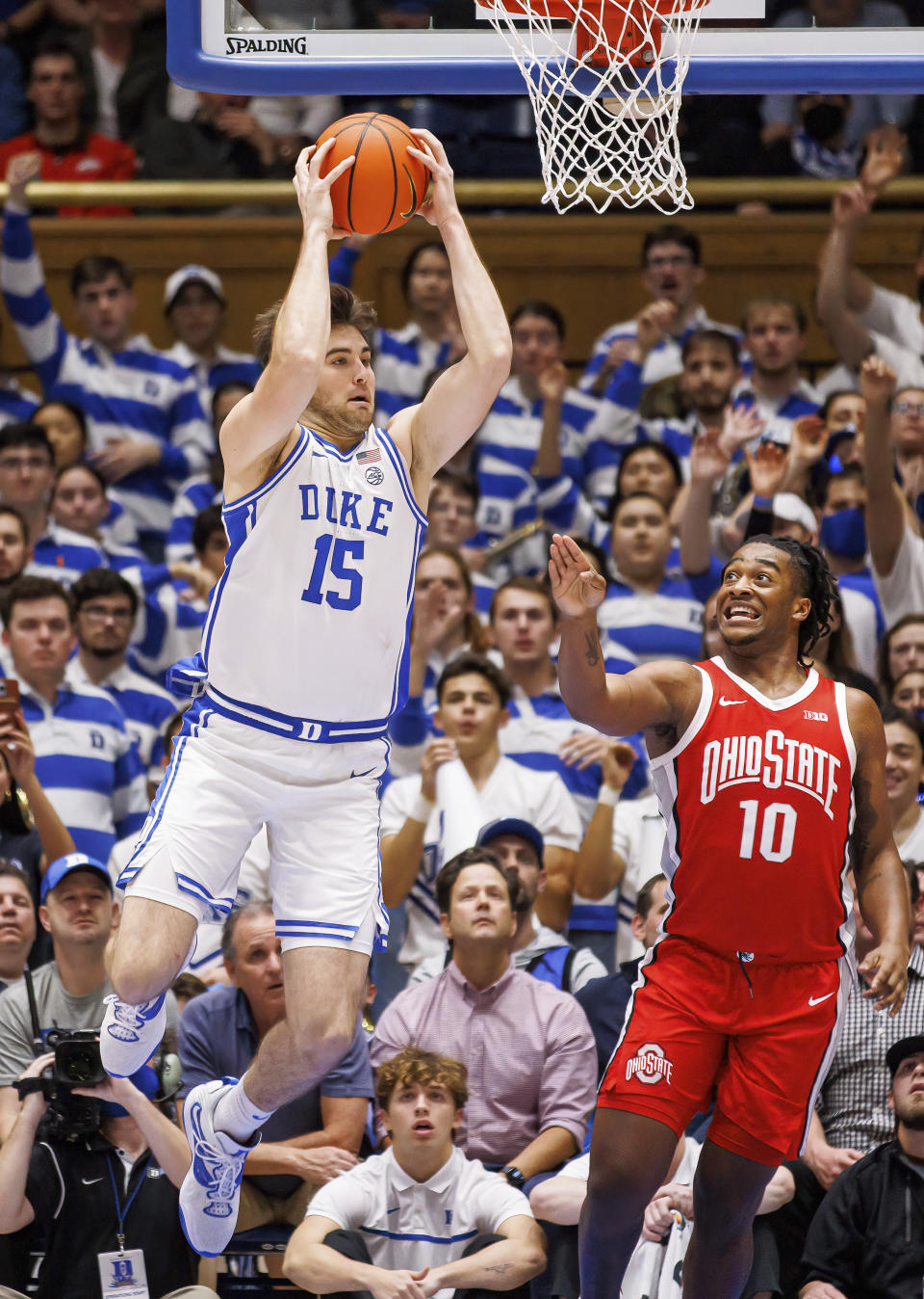 Duke's Ryan Young (15) grabs an offensive rebound ahead of Ohio State's Brice Sensabaugh (10) during the first half of an NCAA college basketball game in Durham, N.C., Wednesday, Nov. 30, 2022. (AP Photo/Ben McKeown)