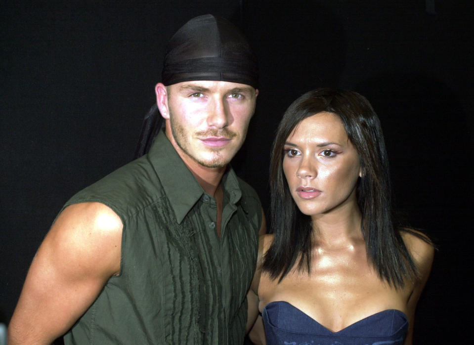 Pop star Victoria Beckham (Posh Spice) and her footballing husband David Beckham wait to meet the Prince of Wales at the Prince's Trust Capital FM Party in the Park, in London. Victoria made her solo debut at the huge outdoor charity show.   (Photo by Matthew Fearn - PA Images/PA Images via Getty Images)