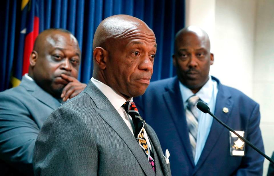 Wake County Sheriff Gerald Baker, left, and Buncombe County Sheriff Quentin Miller, right, listen as Mecklenburg County Sheriff Garry McFadden speaks against House Bill 370 during a press conference at the Legislative Building in Raleigh, N.C., Wednesday, June 19, 2019.