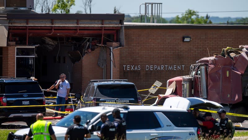 First responders are pictured on the scene after a stolen 18-wheeler crashed into a Texas Department of Public Safety office on US-290 in Brenham, Texas on Friday, April 12, 2024.