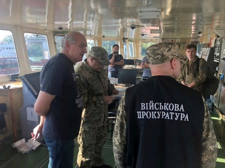 Officers of the Ukrainian security services surround a crew member of the Russian tanker Nika Spirit in Izmail