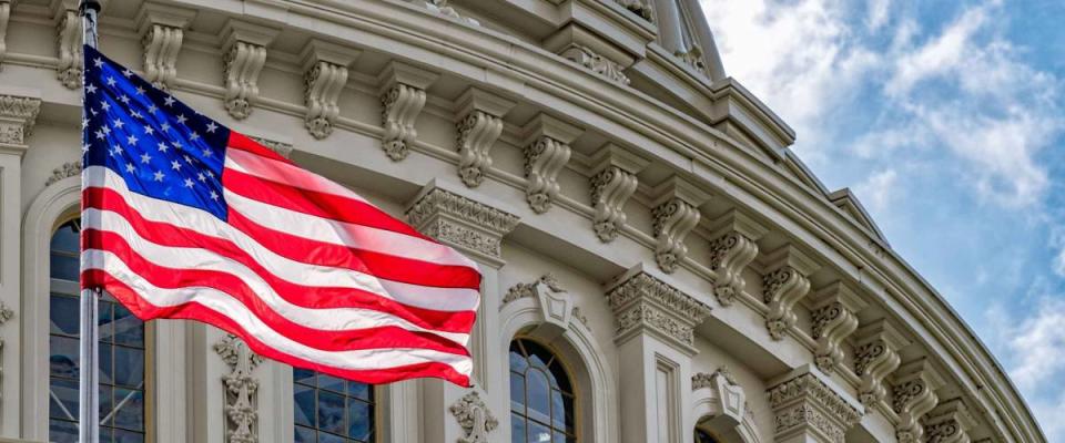 Washington DC Capitol dome detail with waving american flag