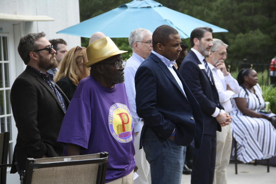 Democratic candidates Rep. Don Davis and state Rep. Terence Everitt listen to speakers at the Granville County Democratic Party fundraiser in Oxford, N.C., while standing among other attendees on Friday, May 10, 2024. The candidates told guests that Granville County could have serious implications on the outcome of the 2024 election. (AP Photo/Makiya Seminera)