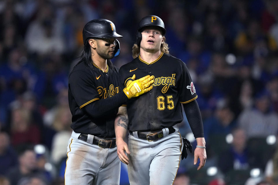 Pittsburgh Pirates' Connor Joe, left, greets Jack Suwinski at home after they scored on Miguel Andujar's double off Chicago Cubs starting pitcher Kyle Hendricks during the third inning of a baseball game Thursday, Sept. 21, 2023, in Chicago. (AP Photo/Charles Rex Arbogast)