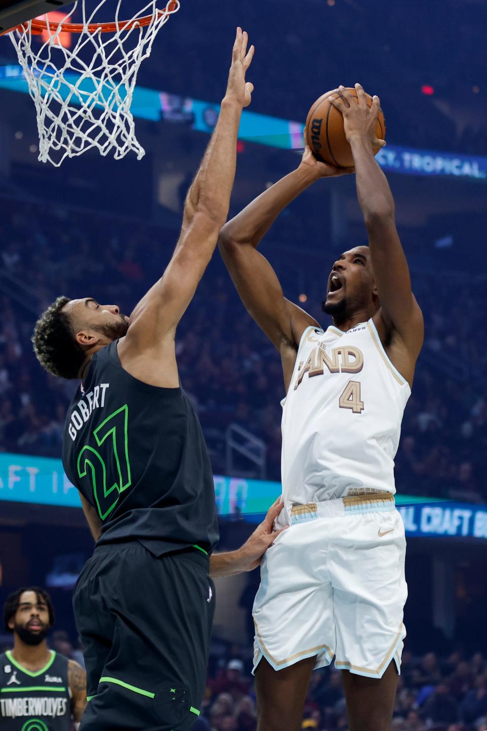 Cleveland Cavaliers forward Evan Mobley (4) shoots against Minnesota Timberwolves center Rudy Gobert (27) during the first half of an NBA basketball game, Sunday, Nov. 13, 2022, in Cleveland. (AP Photo/Ron Schwane)