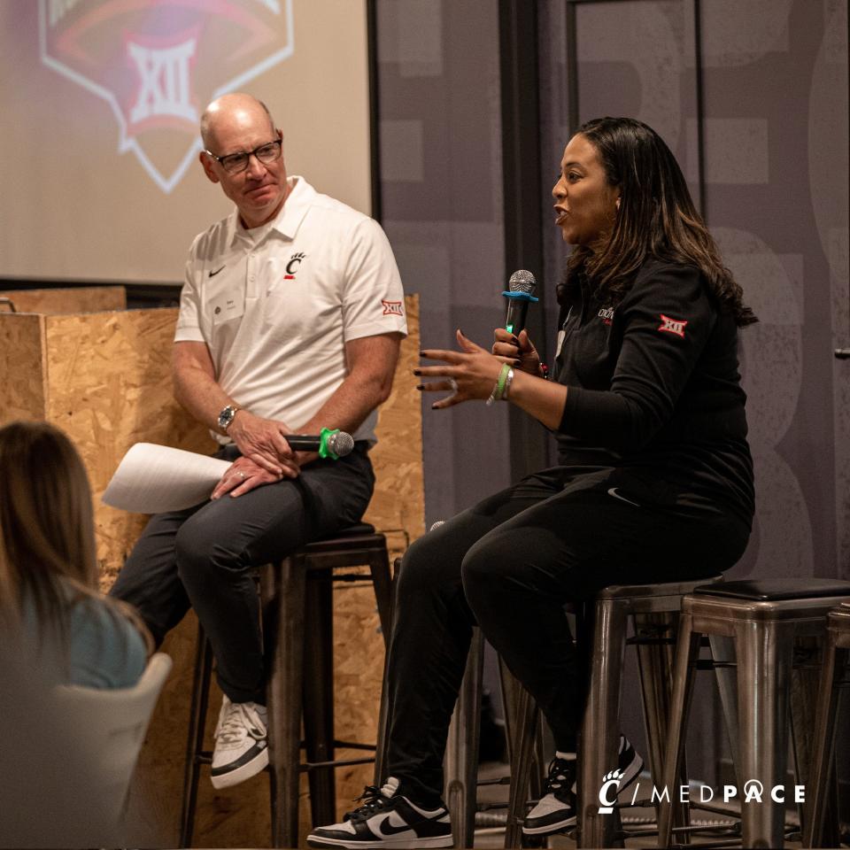 UC broadcaster Dan Hoard questions UC women's basketball coach Katrina Merriweather during the Big 12 rally in Columbus May 18.