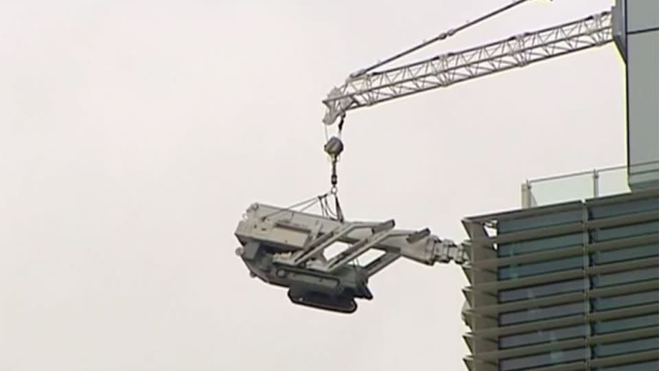 The spider boom crane was bolted to the top floor of the tower lowering machinery from Tower One when it collapsed. Photo: 7 News