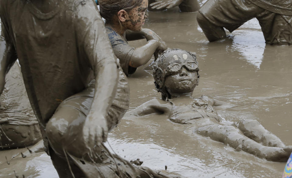 <p>Kids play in the mud during Mud Day at the Nankin Mills Park, July 11, 2017 in Westland, Mich. (Photo: Carlos Osorio/AP) </p>