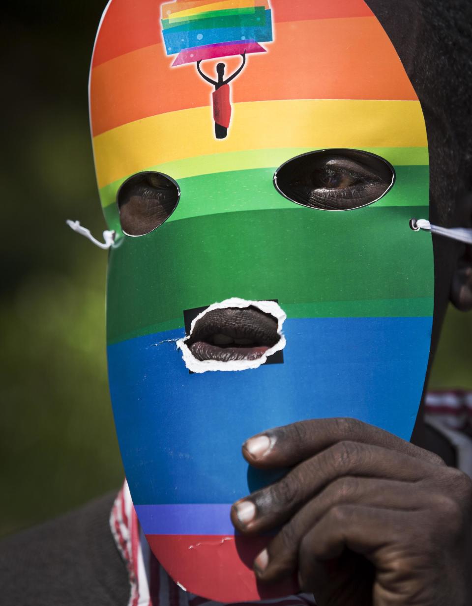 Kenyan gays and lesbians and others supporting their cause wear masks to preserve their anonymity as they stage a rare protest, against Uganda's increasingly tough stance against homosexuality and in solidarity with their counterparts there, outside the Uganda High Commission in Nairobi, Kenya Monday, Feb. 10, 2014. Homosexuality has been criminalized in Uganda where lawmakers have recently passed a new bill, which appears to have wide support among Ugandans, that prescribes life imprisonment for "aggravated" homosexual acts. (AP Photo/Ben Curtis)