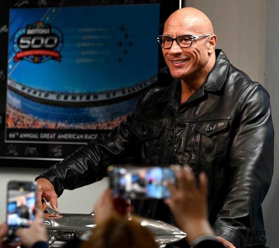 Dwayne “The Rock” Johnson poses with the Harley J. Earl trophy at Daytona International Speedway on Sunday, March 18, 2024. Johnson will be the Grand Marshal for the Daytona 500. The race was postponed on Sunday until Monday, March 19, 2024 due to heavy rain. The Harley J. Earl trophy is given to the winner of the Daytona 500 race.