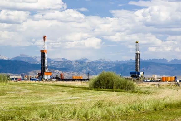 multiple drilling rigs in field.