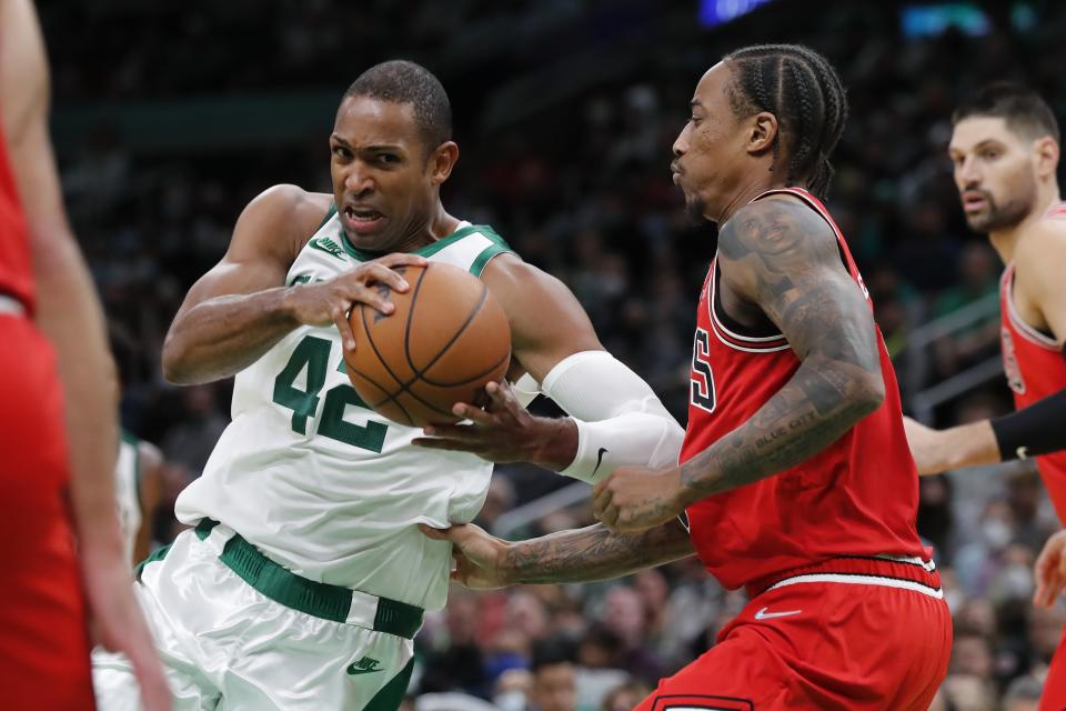 Boston Celtics' Al Horford (42) drives past Chicago Bulls' DeMar DeRozan during the second half of an NBA basketball game, Monday, Nov. 1, 2021, in Boston. (AP Photo/Michael Dwyer)