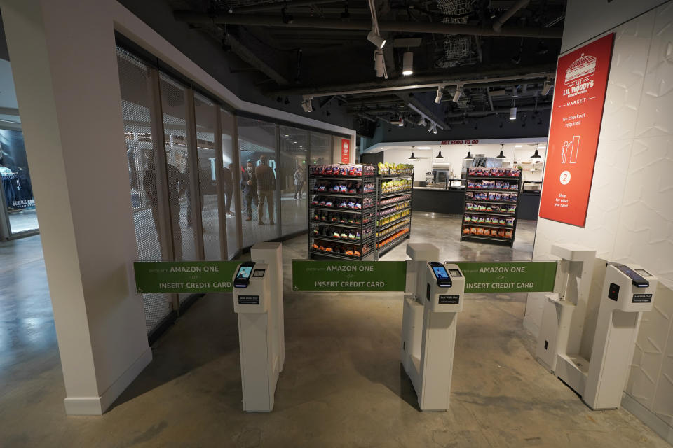 A "Just Walk Out" technology-enabled store is shown inside Climate Pledge Arena, Wednesday, Oct. 20, 2021, during a media tour ahead of the NHL hockey Seattle Kraken's home opener Saturday against the Vancouver Canucks in Seattle. The historic angled roof of the former KeyArena was preserved, but everything else inside the venue, which will also host concerts and be the home of the WNBA Seattle Storm basketball team, is brand new. The technology-enabled store allows fans to insert a credit card or use their Amazon One device at the location's entry gates to shop for snacks and then just walk away as their purchases are automatically tabulated. (AP Photo/Ted S. Warren)