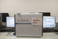 A sign reading "reserved NCOV" hangs on an analysis machine at the Mediterranean institute of infection of La Timone hospital in Marseille, southern France, Thursday Feb. 27, 2020. One by one, more and more countries are reporting cases of the new coronavirus. Governments and doctors on the front lines are scrambling for solutions and everyday life around the globe is being disrupted in a manner that's not been seen in recent times. (AP Photo/Daniel Cole)