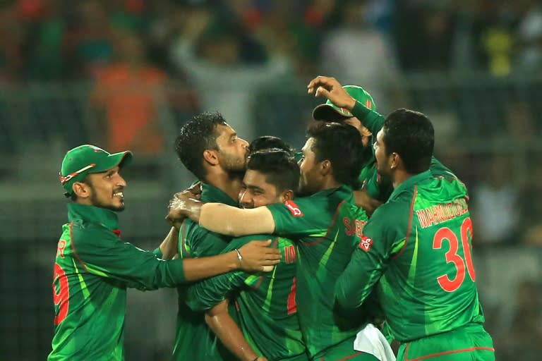 Bangladesh cricketers congratulate Mashrafe Mortaza (2L) after his dismissal of England cricketer Ben Stokes during the second one-day international in Dhaka on October 9, 2016