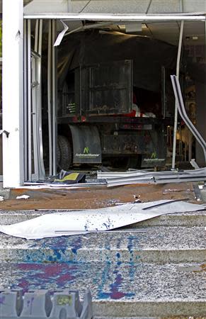 A broken door with a truck is seen at the entrance of the WMAR-TV station in Towson, Maryland May 13, 2014. REUTERS/Jose Magana