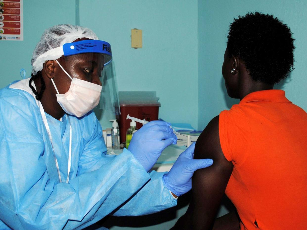 A health worker injects a woman with an Ebola vaccine during a trial in Monrovia n 2015: REUTERS