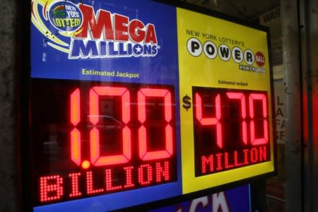 FILE PHOTO: Signs display the jackpots for Mega Millions and Powerball lottery drawings at a newsstands in midtown Manhattan in New York, U.S., October 19, 2018.   REUTERS/Mike Sugar