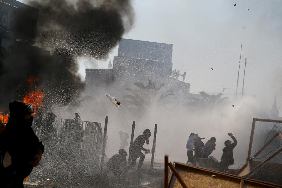 Demonstrators clashing with the riot police