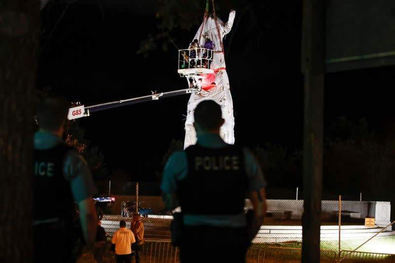 Crew members remove Christopher Columbus statue in Chicago