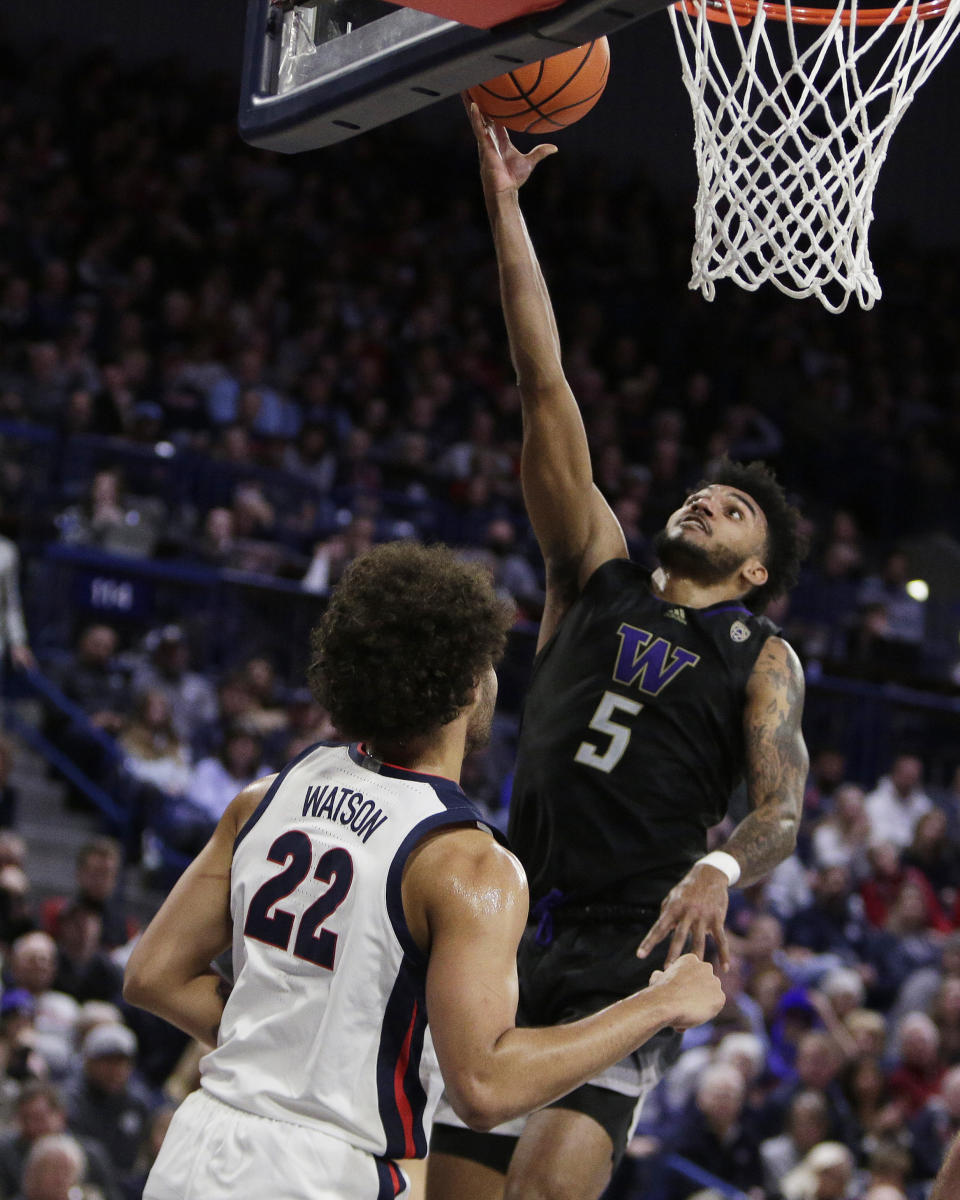 Washington guard Jamal Bey (5) shoots while defended. by Gonzaga forward Anton Watson (22) during the first half of an NCAA college basketball game, Friday, Dec. 9, 2022, in Spokane, Wash. (AP Photo/Young Kwak)