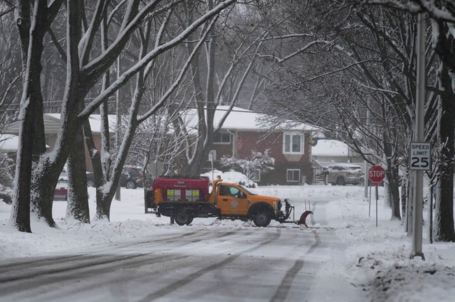 A snow plow cleans the road as a winter storm arrives in Wheeling, Ill., Friday, Jan. 12, 2024. (AP Photo/Nam Y. Huh)