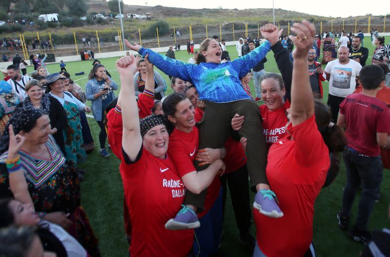 Aida, 41, celebrates the victory of her team, in an annual local soccer tournament in the village of Sahel