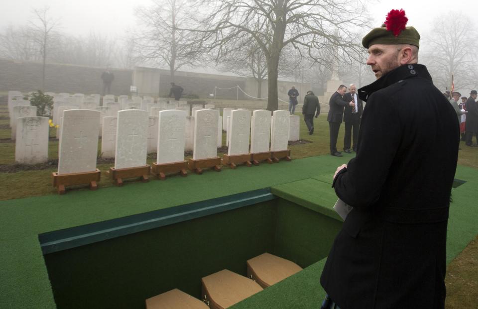 Stephen McLeod, grand nephew of World War One soldier William McAleer looks toward graves during a reburial service at the Loos British World War One cemetery in Loos-en-Gohelle, France on Friday, March 14, 2014. Private William McAleer, of the 7th Battalion, Royal Scots Fusiliers, was killed in action on Sept. 26, 1915 during the Battle of Loos. His body was found and identified in 2010 during routine construction in the area and is being reburied with full military honors along with 19 unknown soldiers. (AP Photo/Virginia Mayo)